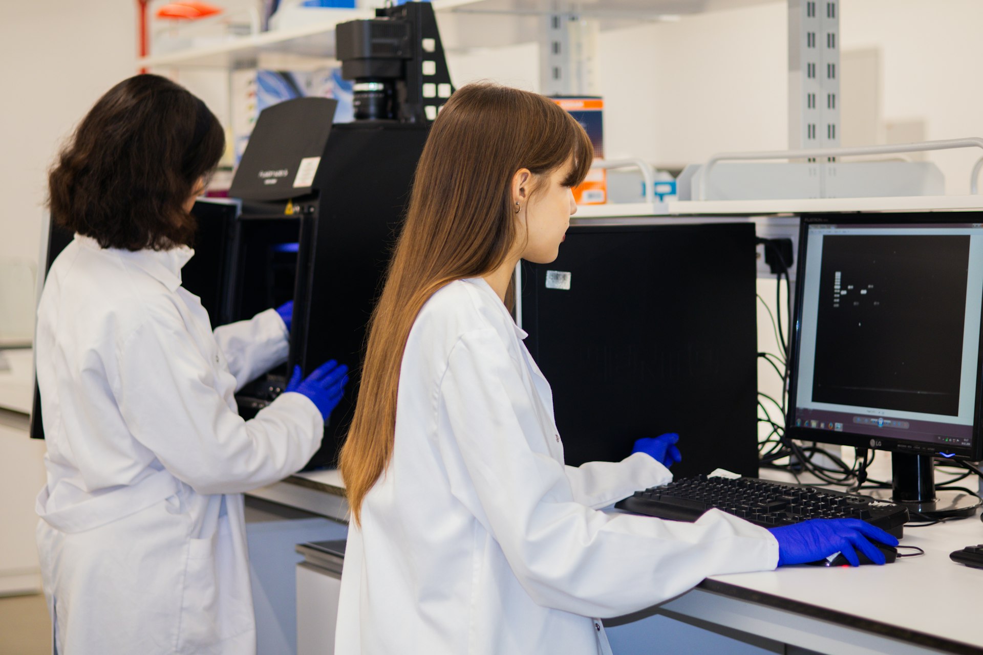 Two scientists working on computers in a laboratory